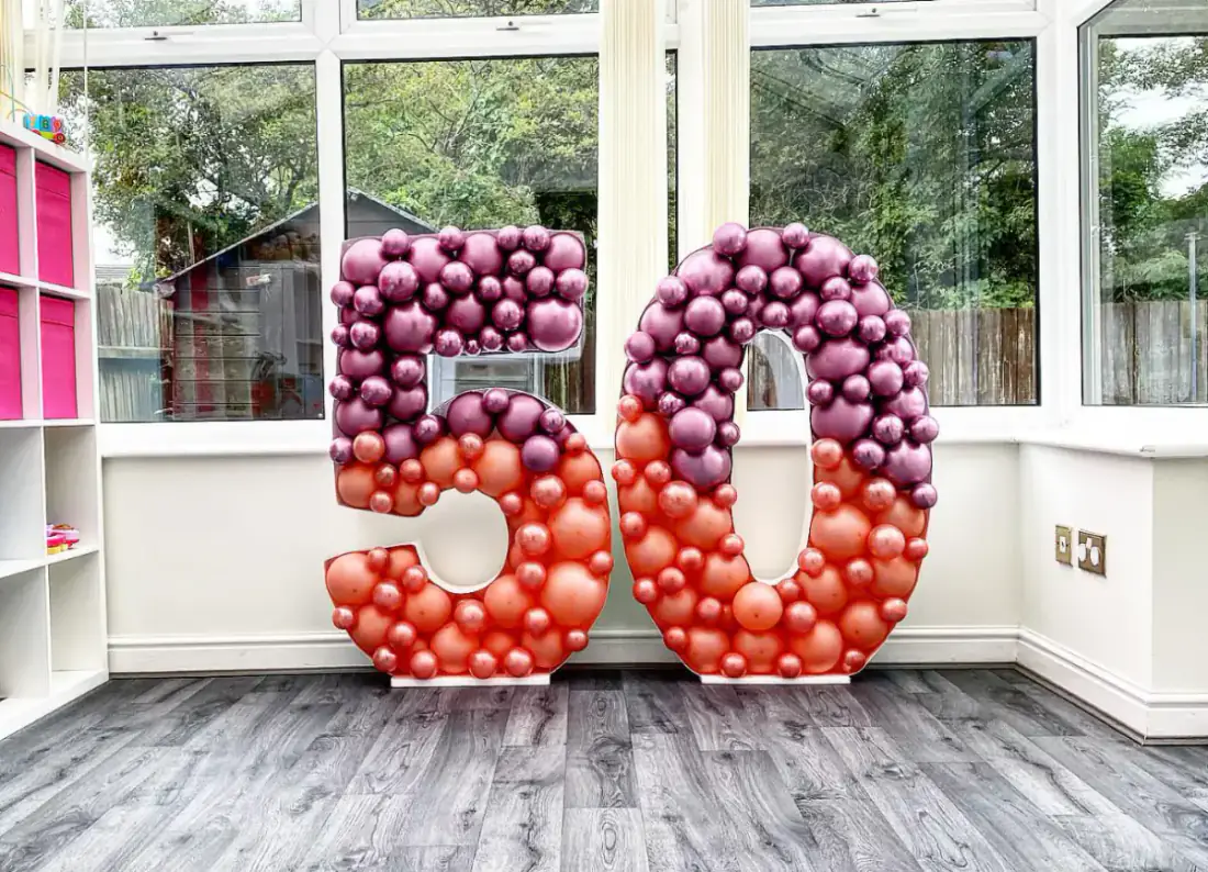 Ombre red and purple balloon styling around 50 numbers