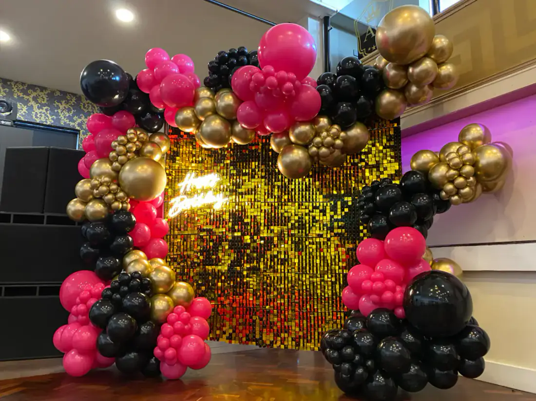 Hot pink black and gold 18th shimmer wall with LED numbers