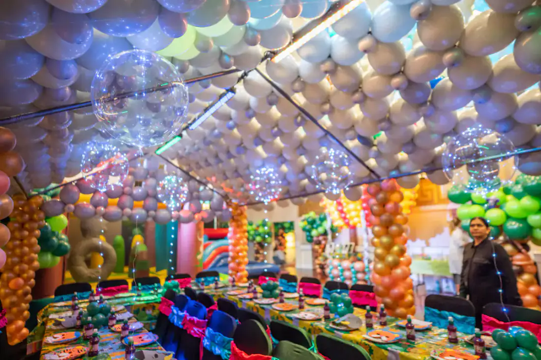 Finished first birthday celebration room with rain forest balloon decor