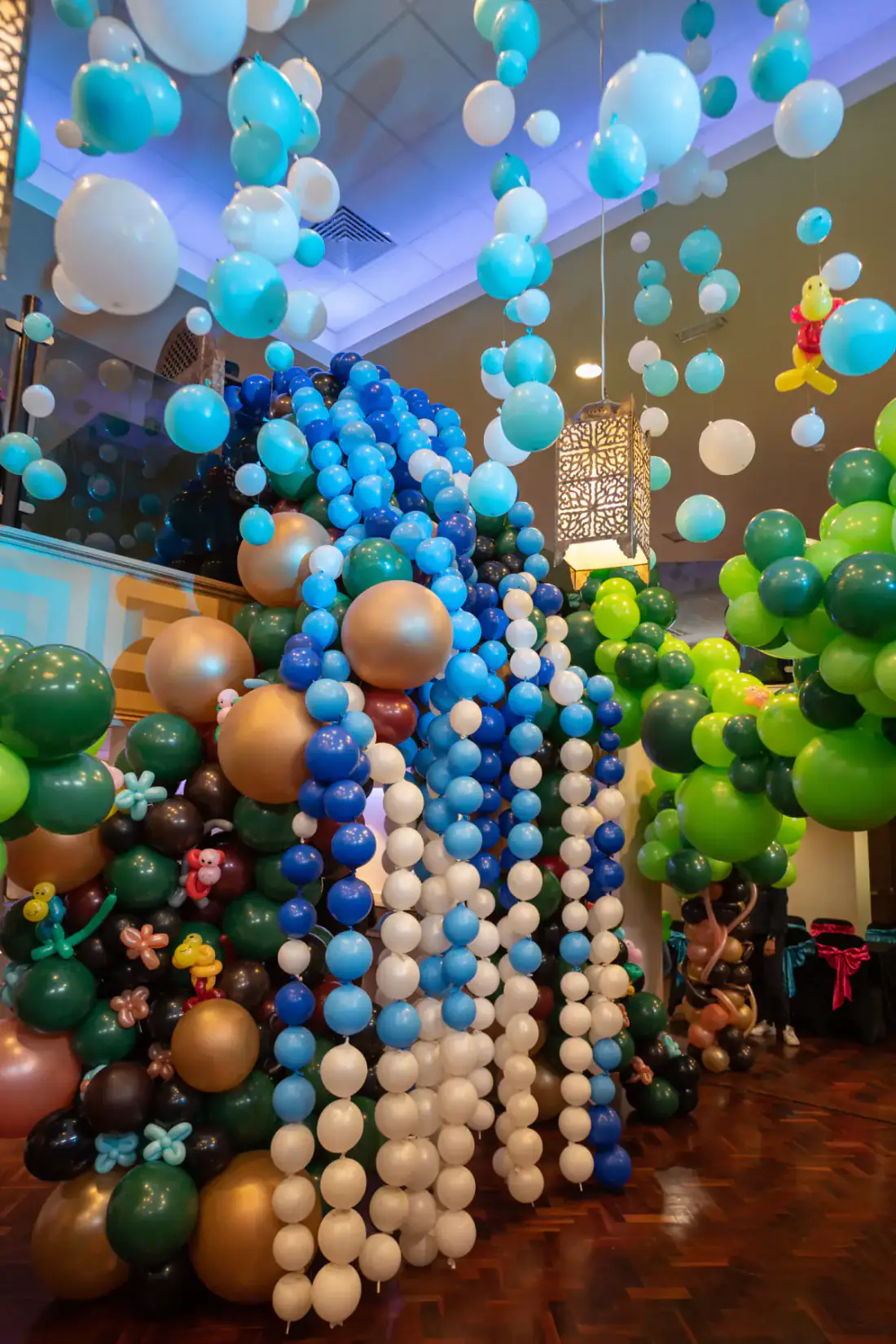 Twenty foot balloon waterfall feature in the rain forest birthday installation
