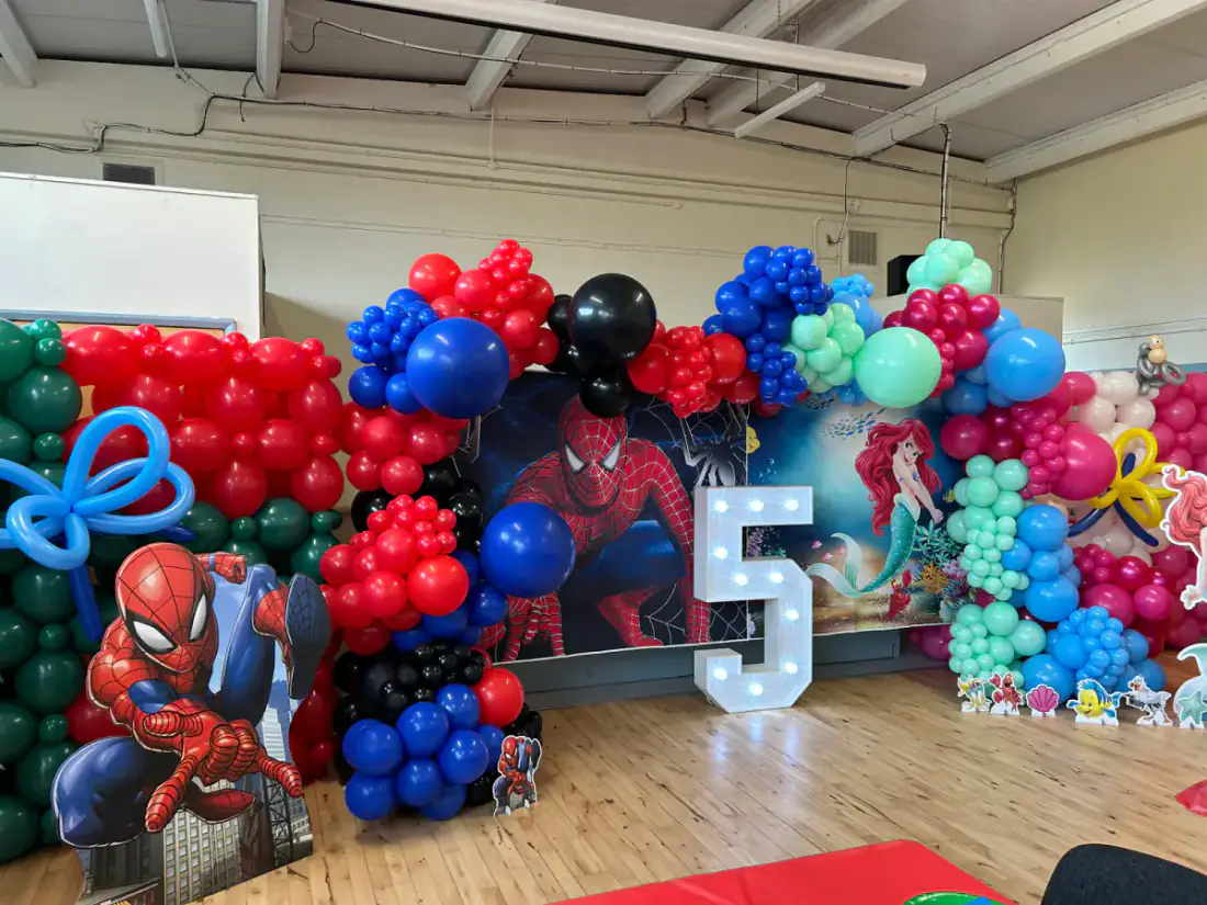 Superhero themed fifth birthday display with light up number five