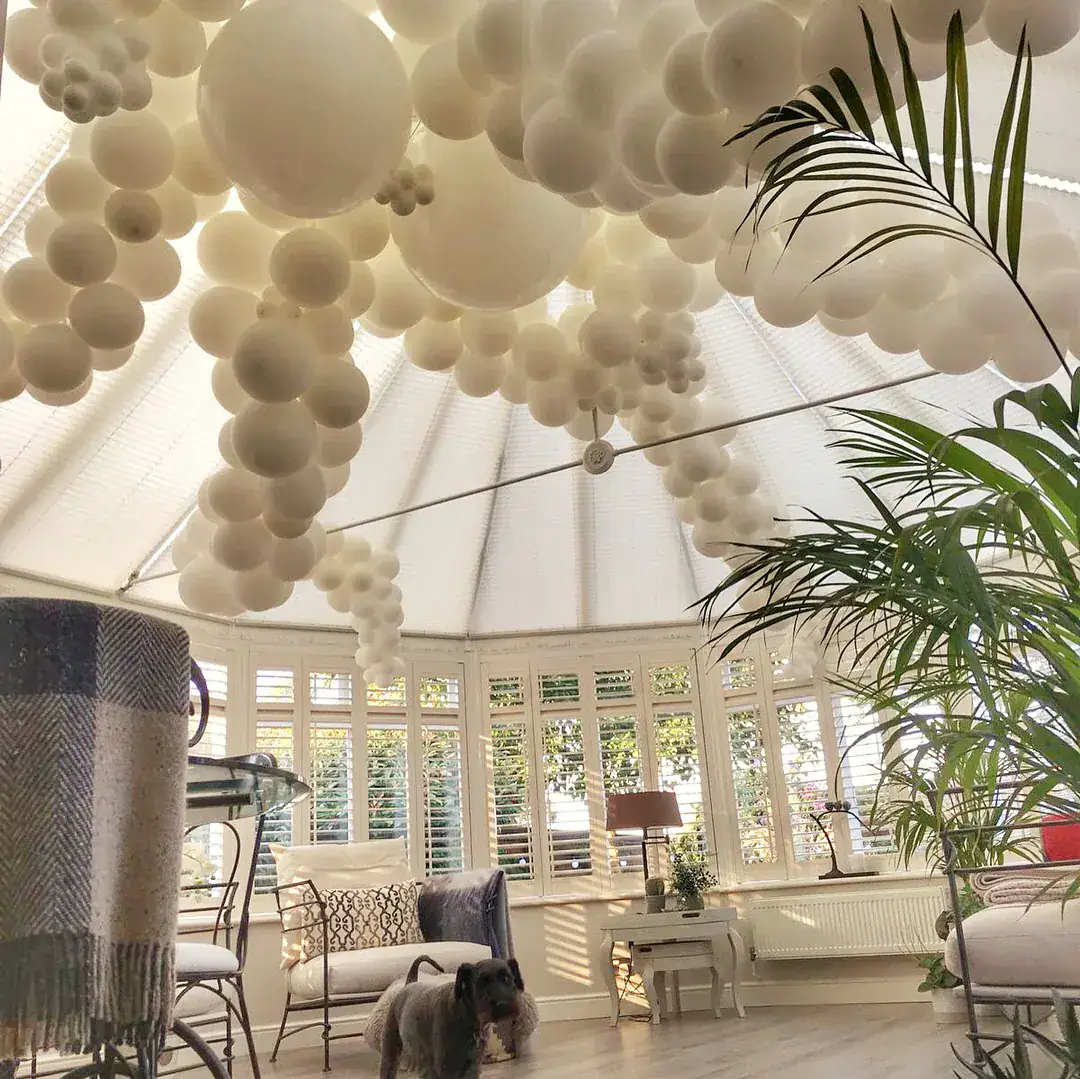White organic balloon ceiling installation over wedding lounge area