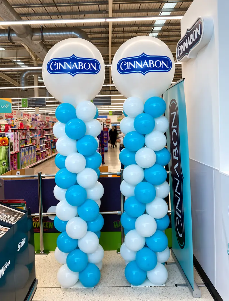 Cinnabon branded blue and white balloon columns in a retail store