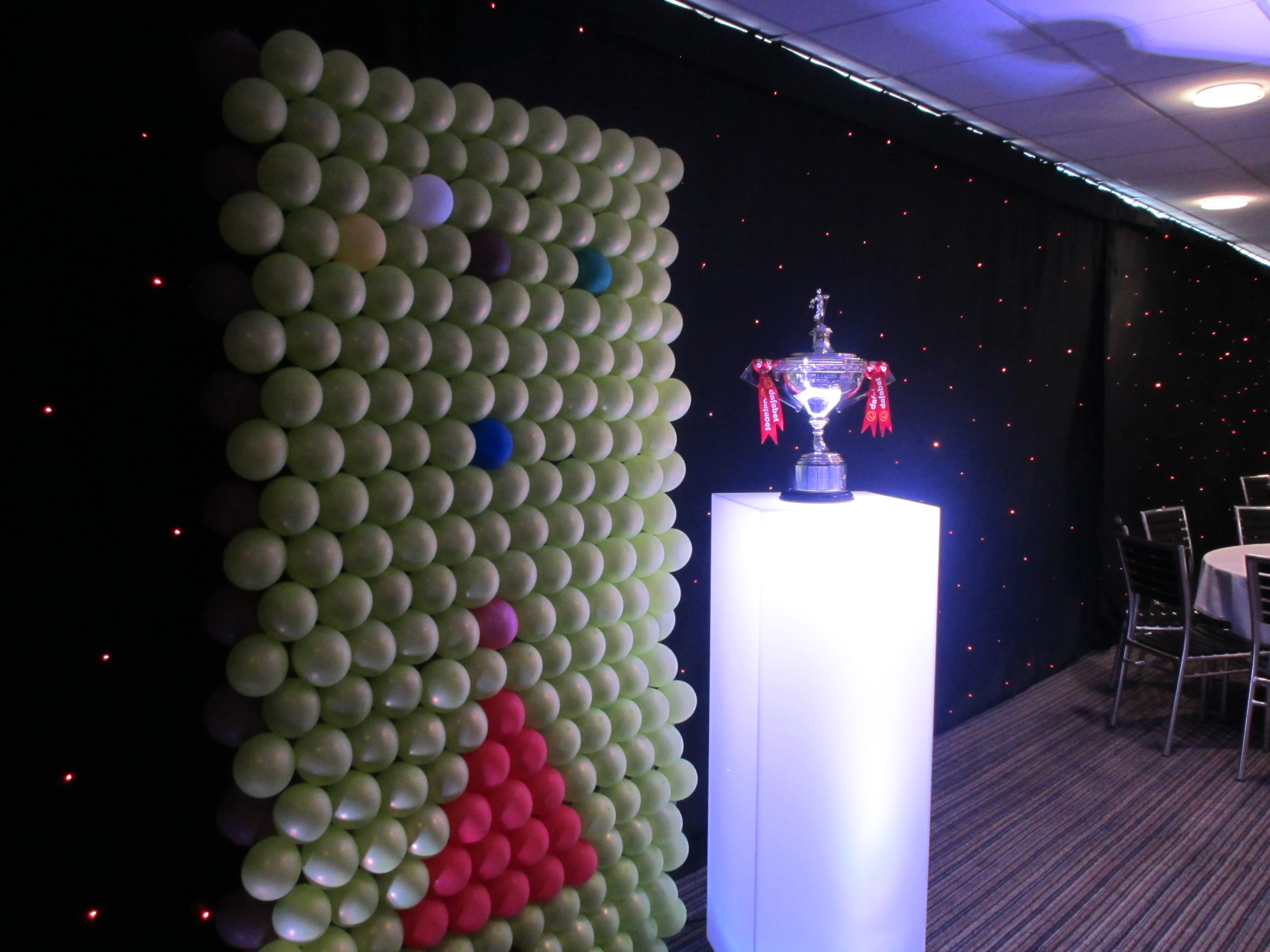 Large balloon wall installation beside a lit display plinth