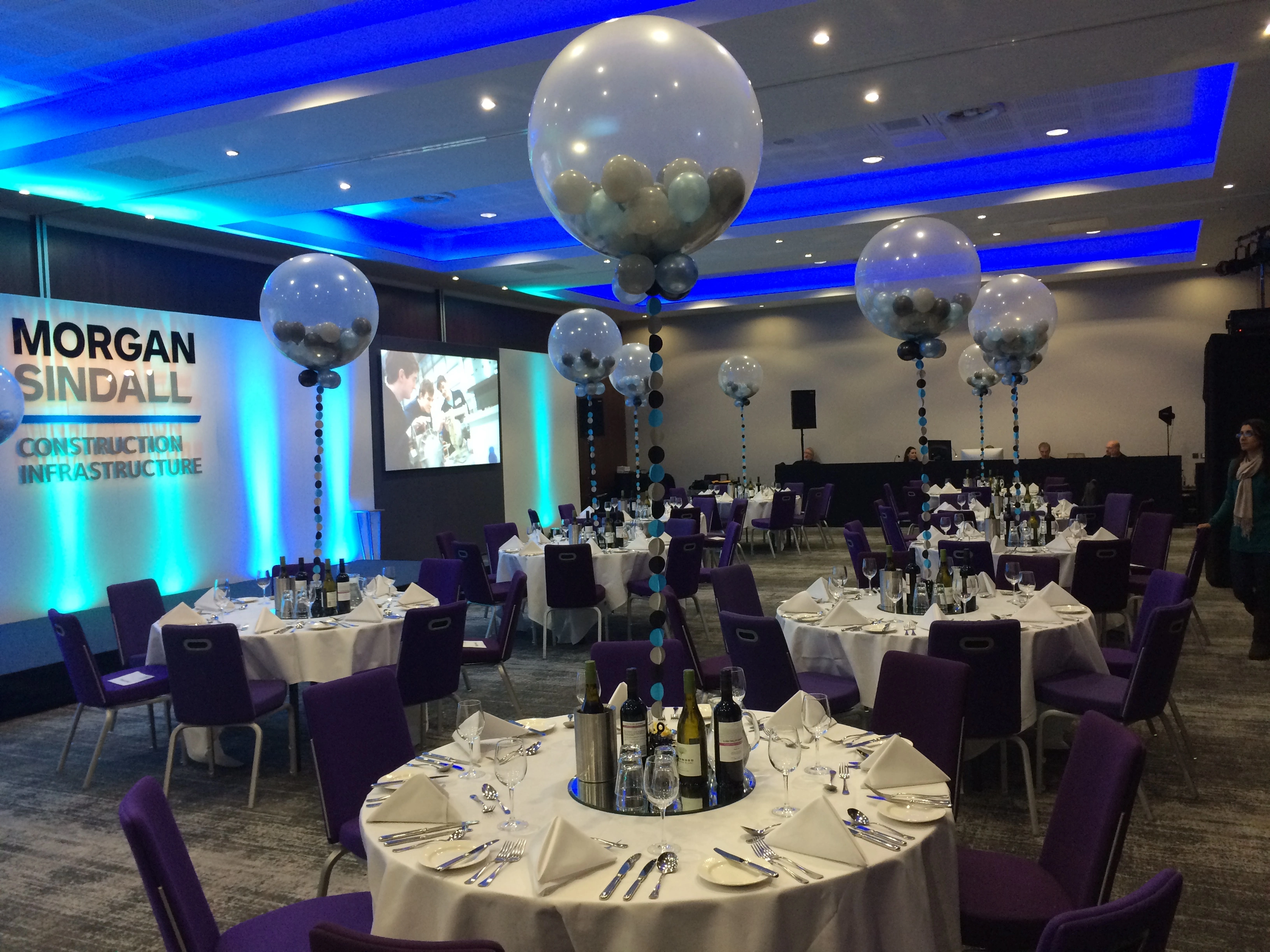 Conference tables with clear balloon centrepieces in a corporate venue
