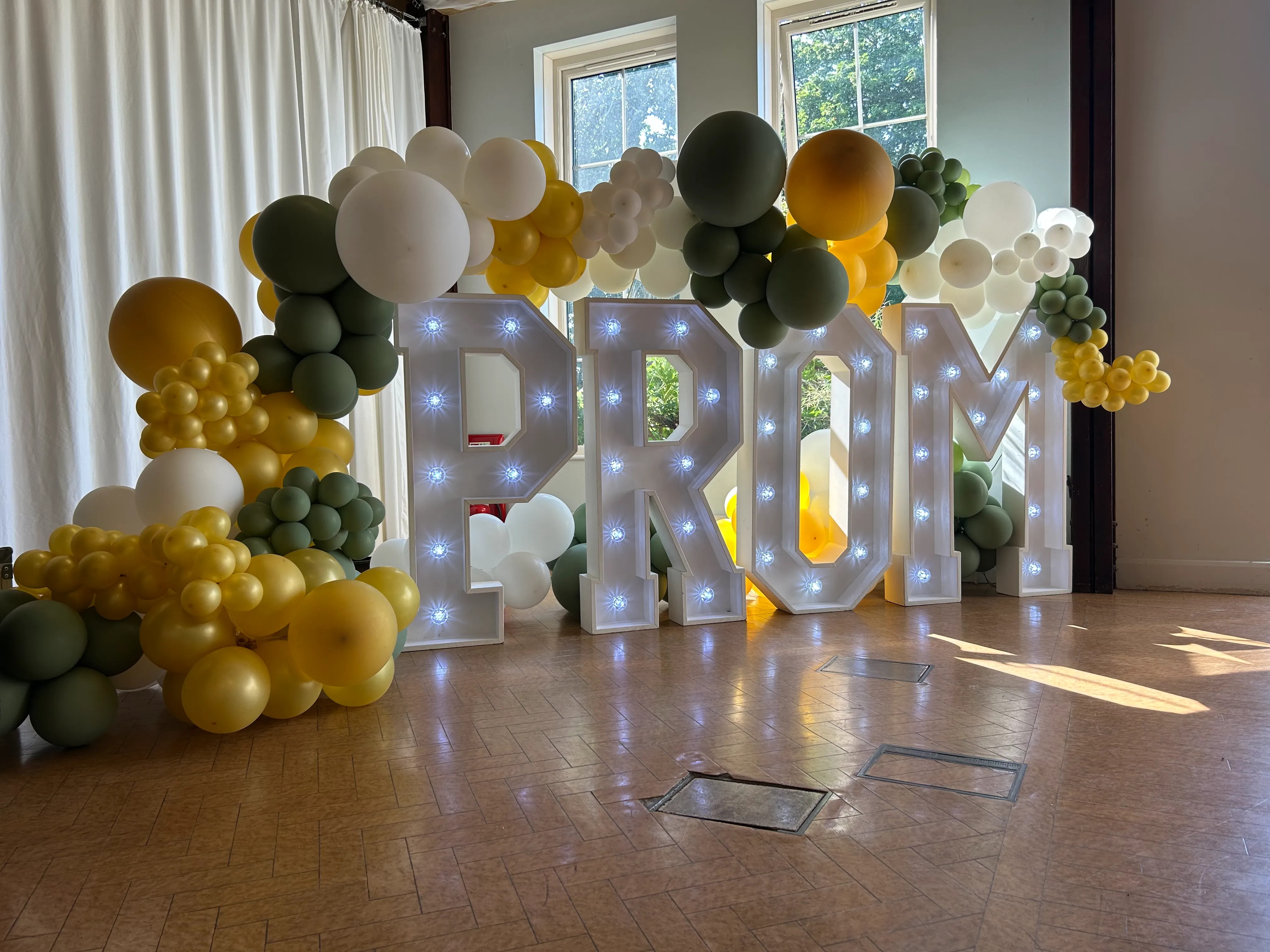 Black, white and gold prom balloon feature wall with light up PROM letters
