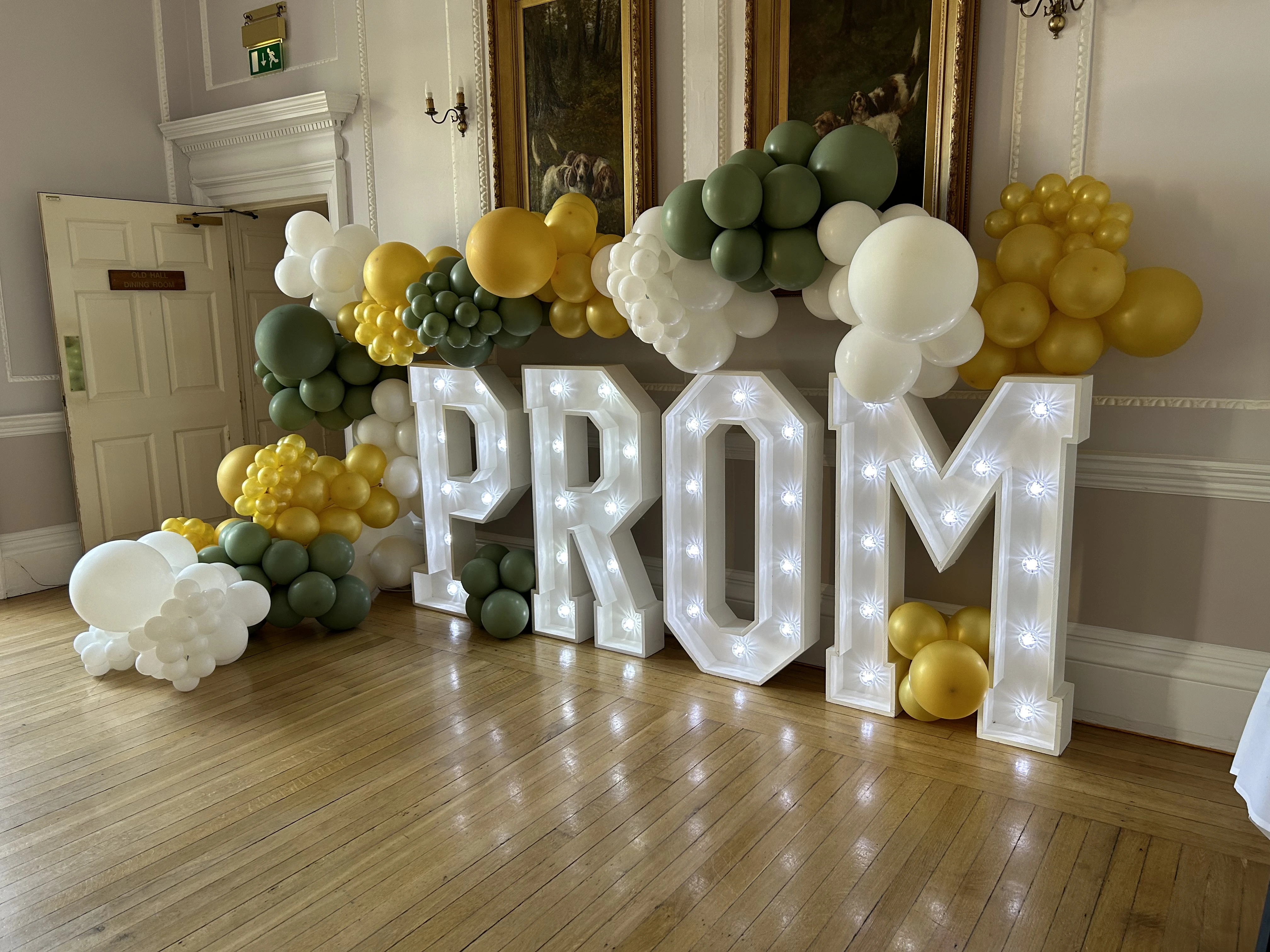 Green, white and gold prom balloon display with light up PROM letters