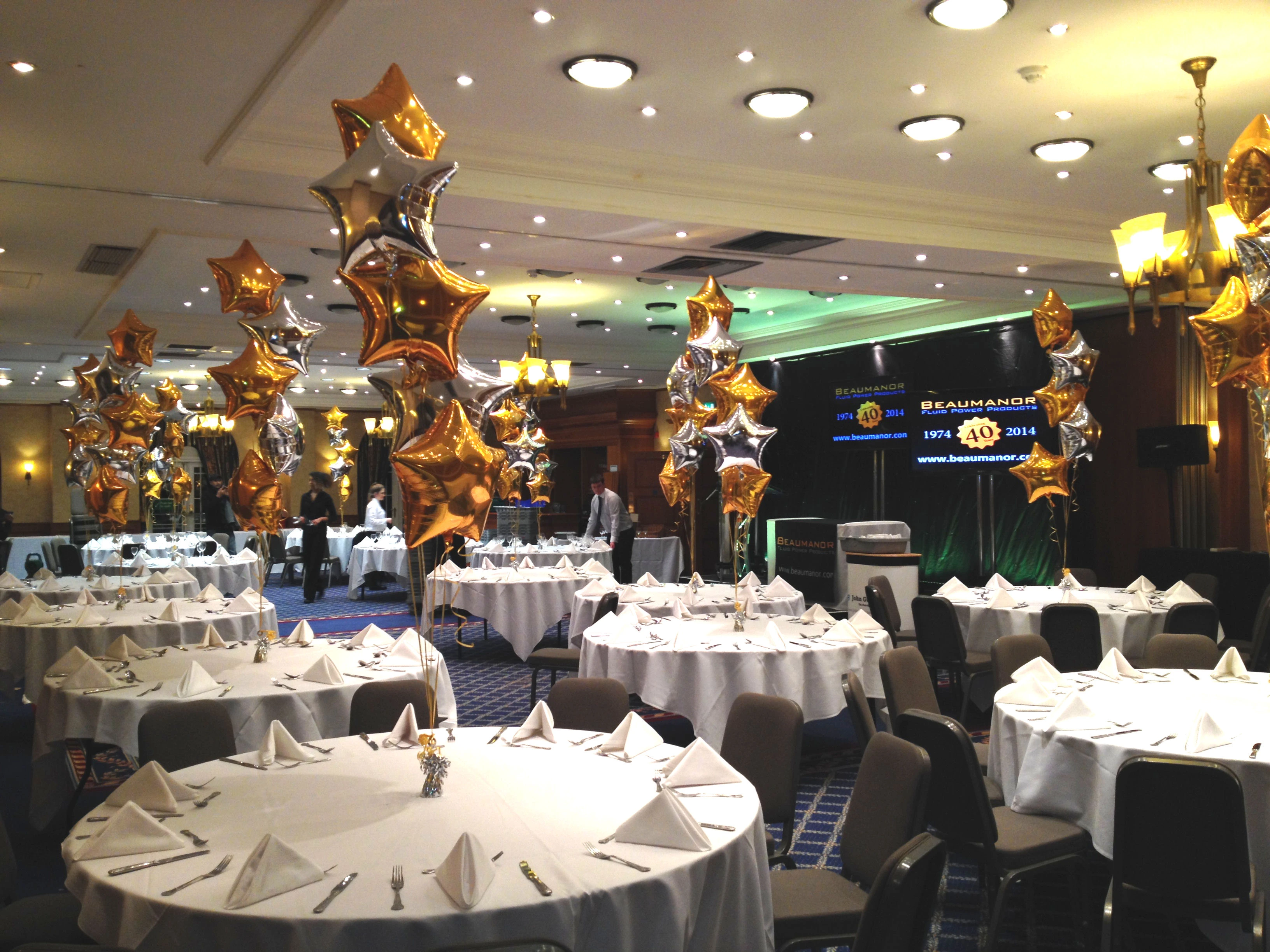 Prom venue tables with metallic star balloon centrepieces