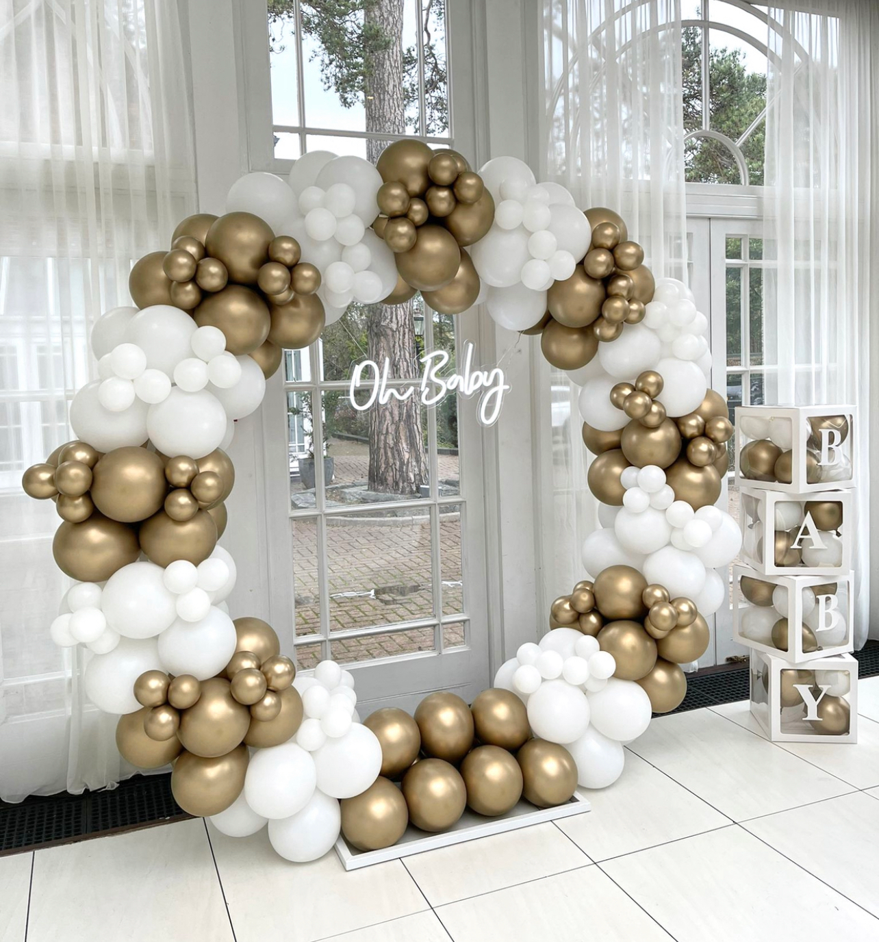 Baby shower balloon backdrop with soft celebration styling